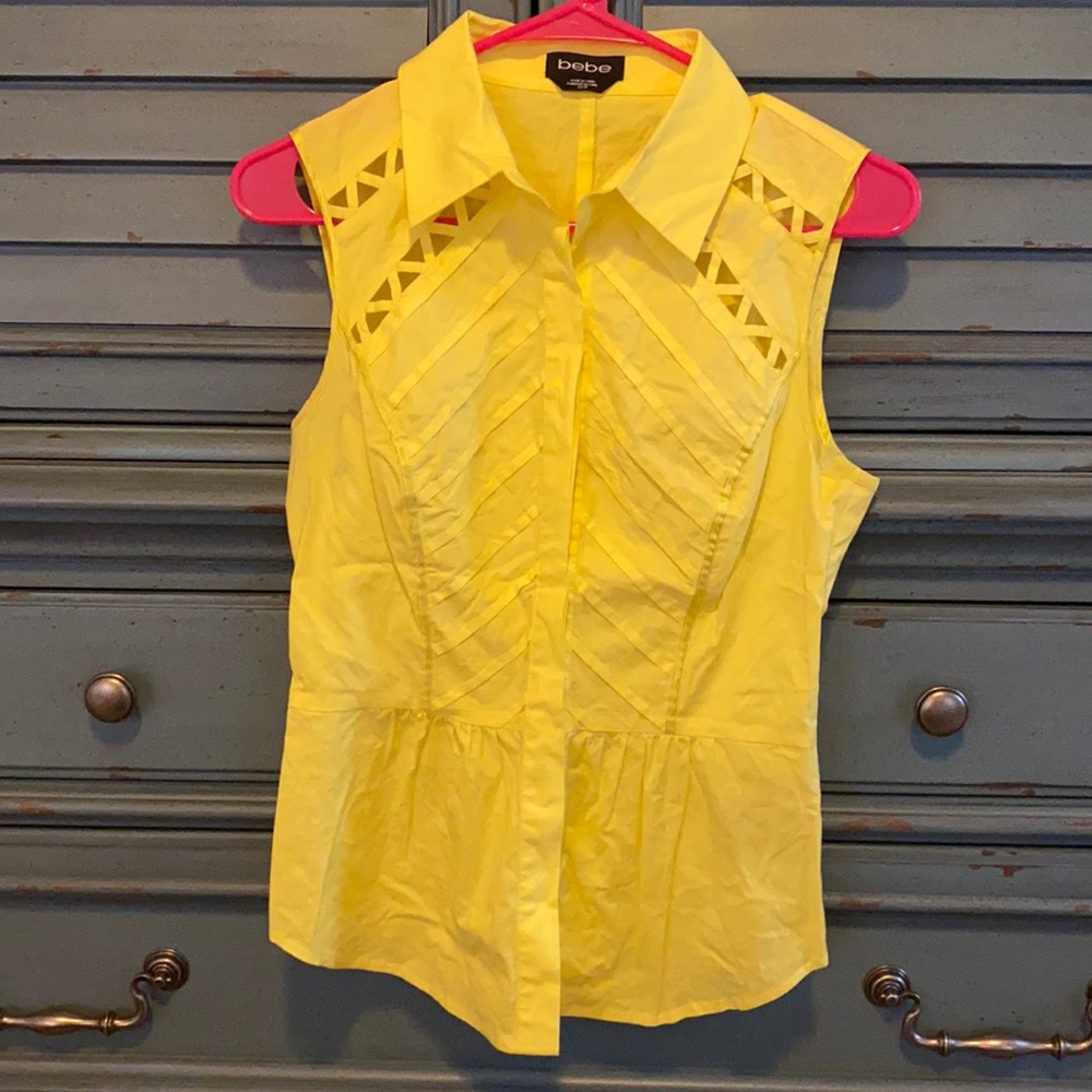 This is a women’s yellow sleeveless top.